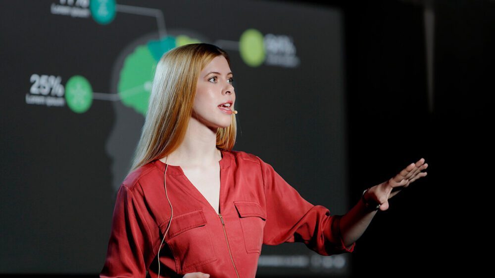 A woman delivering a keynote talk.