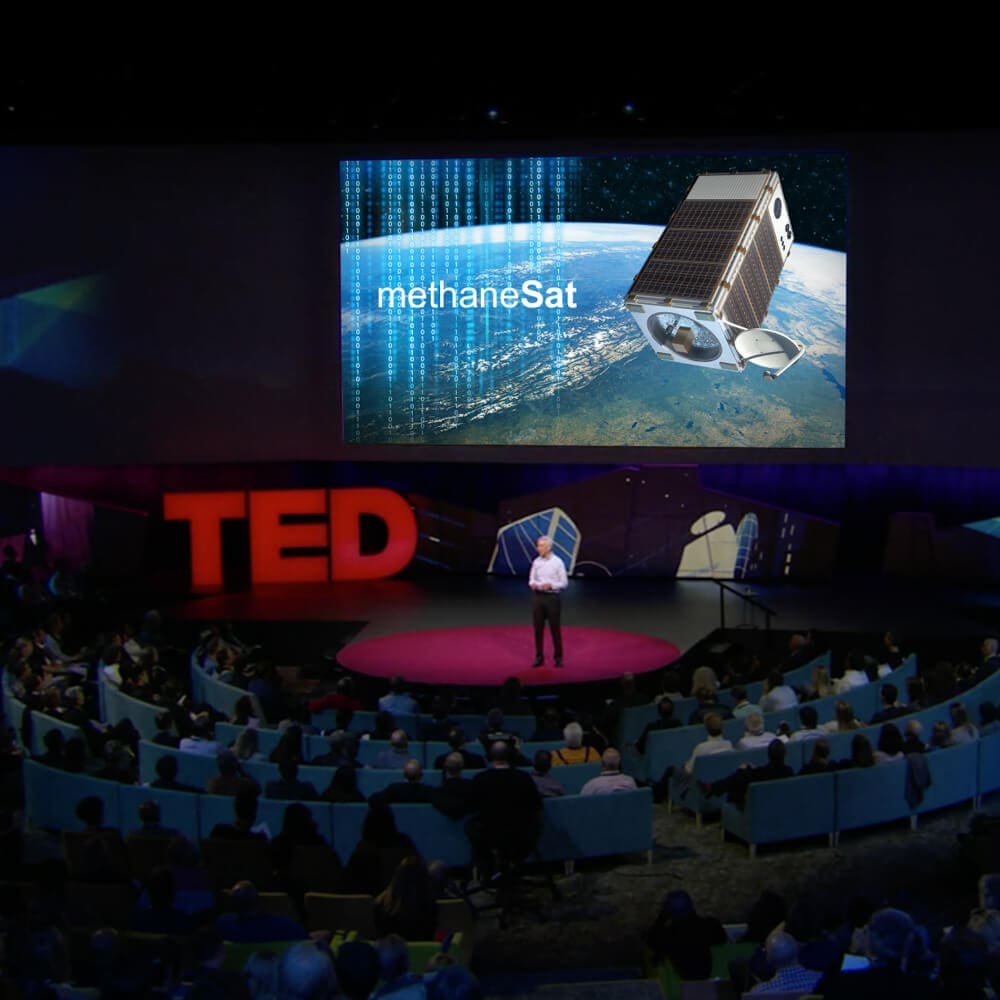 man on stage delivering a ted talk speech